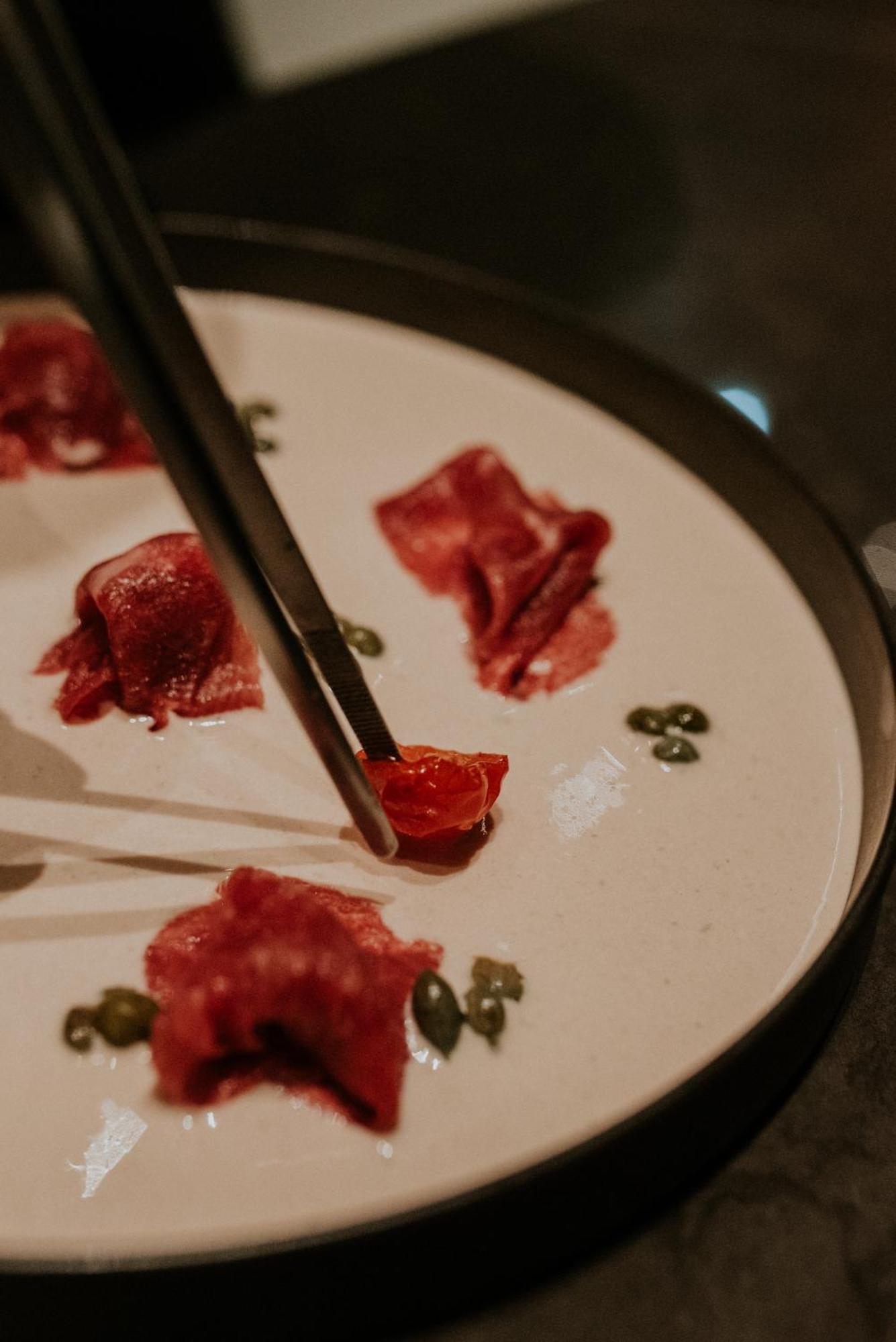 Kozmo Hotel Suites & Spa - Small Luxury Hotels Of The World Budapest Exterior photo A piece of beef being held with a pair of chopsticks
